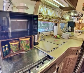 Fridge, microwave, coffee/tea maker, cookware/dishes/utensils