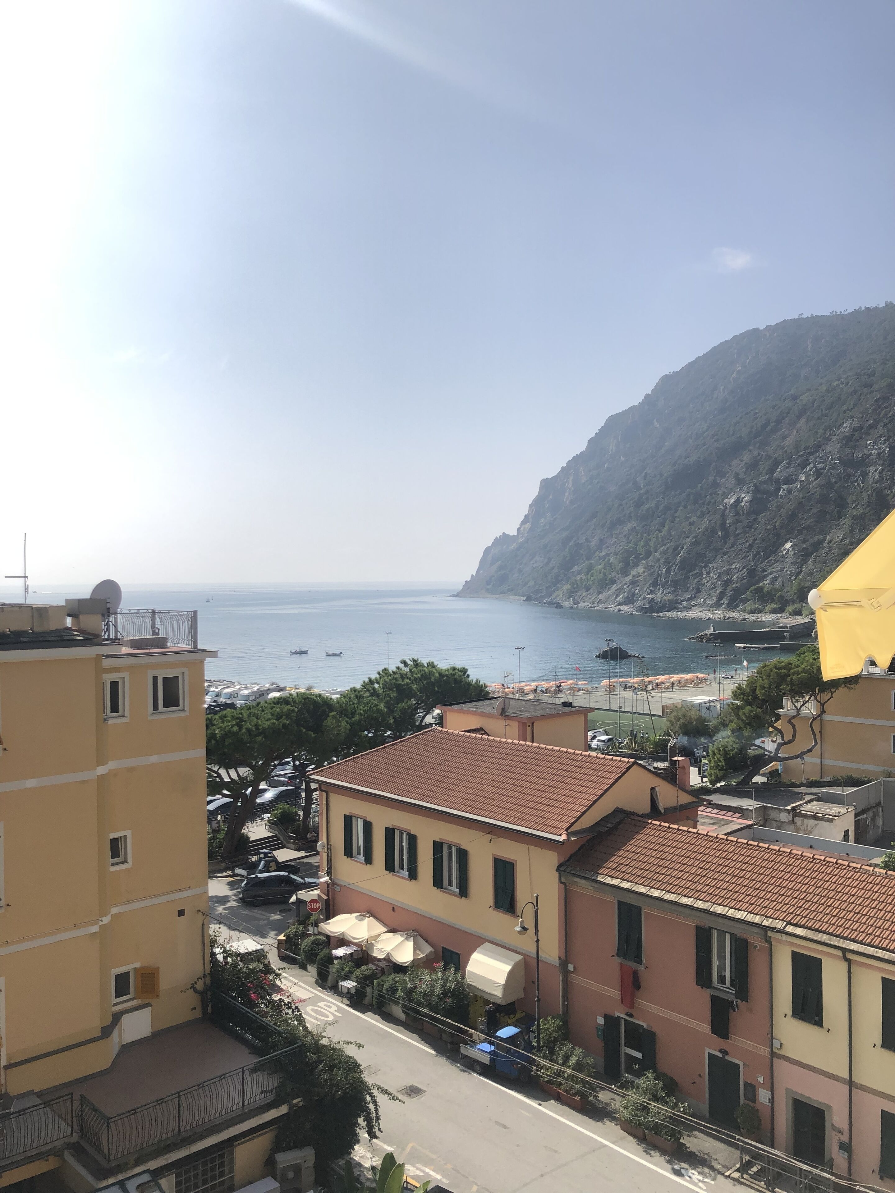 A coastal town with buildings, a street, and a view of the sea.