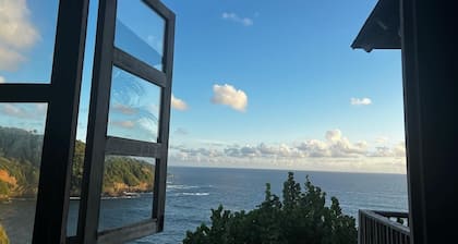 Private wooden villa with stunning ocean views, in an enchanting garden setting.
