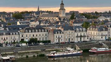 A river with boats, a bridge, and buildings along the riverbank.