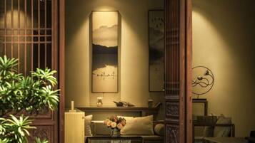 A traditional Japanese-style room with tatami flooring, a low table with cushions, and a shoji screen.