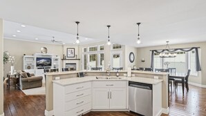 A spacious kitchen with a large island, white cabinetry, and a dishwasher. - Private luxury in beautiful Yakima wine and hop country (Naches)