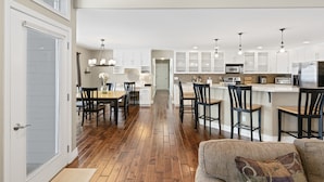 A modern kitchen with white cabinets, a central island, and bar seating. - Private luxury in beautiful Yakima wine and hop country (Naches)