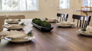 A dining table set with plates, napkins, and a decorative centerpiece. - Yellowstone Adventure-Island Park (Island Park)