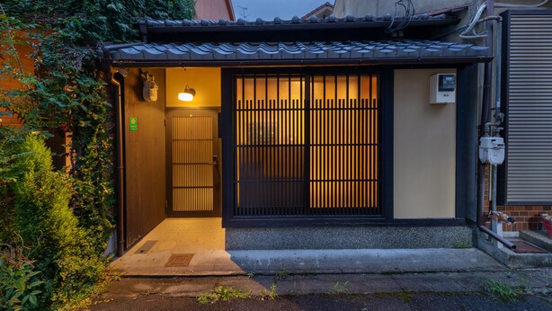 A traditional Japanese house with a tiled roof, a sliding door, and a small entrance area. - Kanade Sanjusangendo (Kyoto)