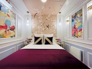 A hotel room with a large bed, two nightstands, a ceiling with floral artwork, and wall paintings. - Merveil - Luxury Suite - Marais - Charlot (Paris)