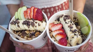 Two cups of food with bananas, strawberries, and granola. - Larger Room In Parap, saltwater pool, close to markets, Great coffee, Central. (Parap)