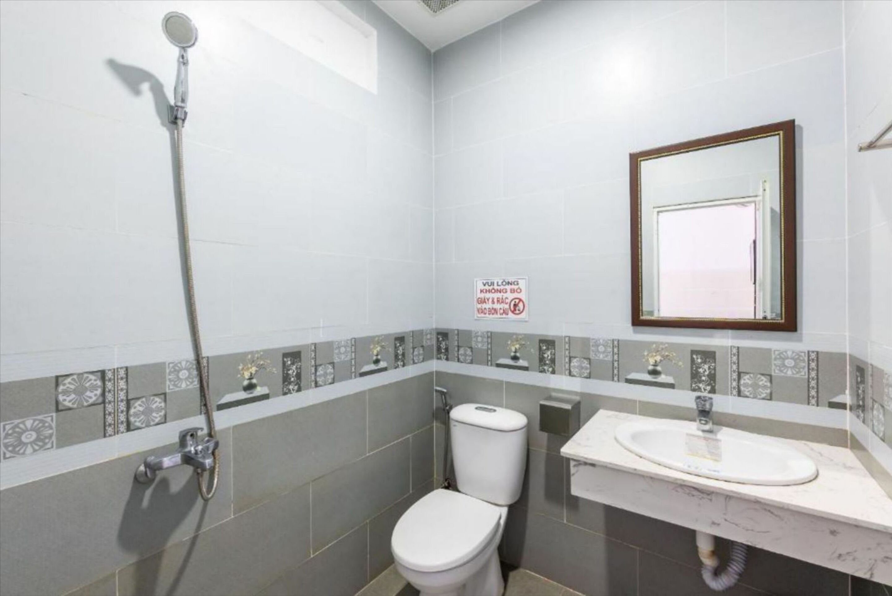A bathroom with a toilet, a sink, and a shower.