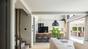 A modern kitchen with a central island, bar stools, and pendant lighting. - Luxury Villa with Sea Views, Fire Pit & near beach (Rethymno)