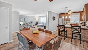 A spacious living area with a dining table, kitchen, and a ceiling fan. - Single Story Henderson 3BR Home, Hot tub, Sleeps 6 (Henderson)