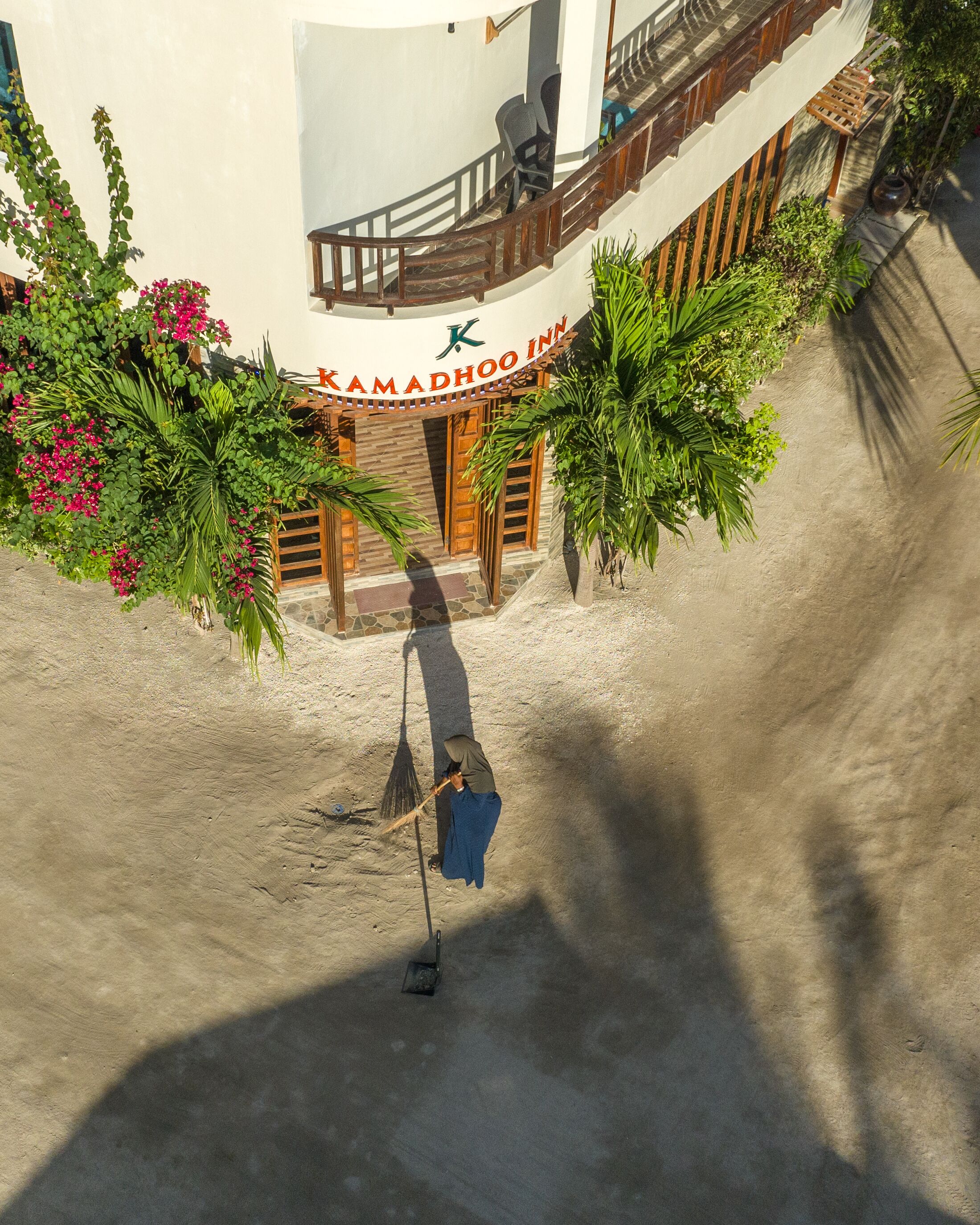A hotel entrance with a sign reading "Kamadhoo Inn".