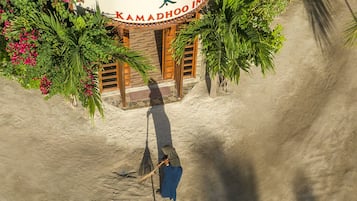 A hotel entrance with a sign reading "Kamadhoo Inn".