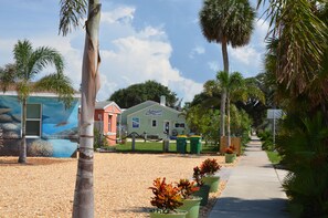 Surrounded by lush palm trees and vibrant potted plants, the Hurricane Inn offers a tranquil retreat.