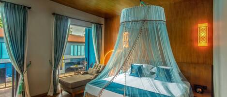 A bedroom with a bed under a canopy, a sofa, and a view of the outside.