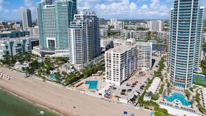 A high-rise hotel with multiple balconies, a pool area, and a beachside location. - Deluxe 1-bed 2-bath ocean front free valet parking on the beach (Hollywood)