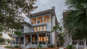 A two-story house with a porch, a covered front entrance, and a driveway.