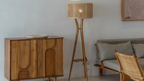 A room with a wooden cabinet, a floor lamp, and a sofa. - Villa Eliad - 3 Bedroom Villa in Berawa (Canggu)