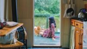 A room with a sliding door leading to a balcony. - Snug secluded lakeside shepherds hut for fishing, or just relaxing.  (Hadlow Down)