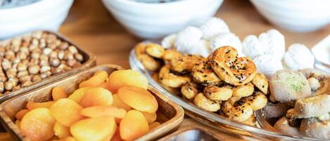 A variety of snacks and dips arranged on a wooden table.