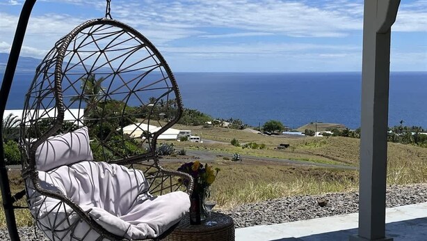 A hanging chair with a view of the ocean. - Hale Lewa ~ Newer Home ~ Ocean Views ~ 30 Day Rent (Waimea)