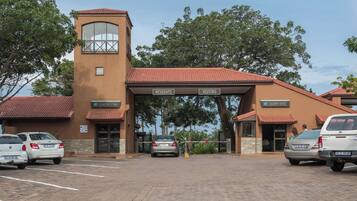 Stunning estate with a two-story facade, red-tiled roof, and a welcoming entrance.