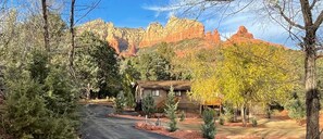 A rustic cabin with a dirt road leading to it, surrounded by trees and red rock formations in the background. - Sedona Forest Villa Land Nature Lover S Private Paradise (Sedona)