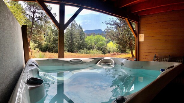 A hot tub with a clear view of a mountainous landscape through an open wooden structure. - Sedona Forest Villa Land Nature Lover S Private Paradise (Sedona)