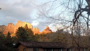 A two-story building with a wooden deck and a staircase leading to the upper level. - Sedona Forest Villa Land Nature Lover S Private Paradise (Sedona)