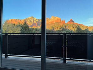A balcony with a view of red rock formations and sparse vegetation. - Designer View Villa-rooftop 360 View Deck-hot Tub (Sedona)