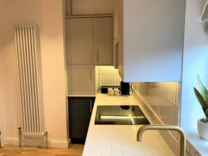 A modern kitchen with a built-in dishwasher, a small refrigerator, and a countertop with a coffee maker. - Escape 2 Unwind Minster Retreat - Sleeps 5 (York)