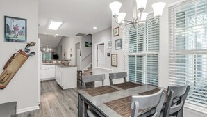 A dining area with a table, chairs, and a chandelier. - TB 93C Wonderful 3/bed 2/bath Garden home in True Blue (Pawleys Island)