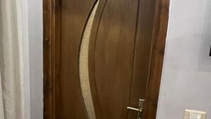 A wooden door with a decorative design and a light switch on the wall. - Thomas Cook pyramids  guest house (Giza)