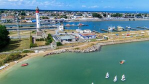 An aerial view of a coastal town with a lighthouse, marina, and several sailboats. - Entire Seaside House, 160m² – 3 Bedrooms, Sleeps 6 (Ouistreham)