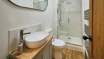 Shower, hair dryer, towels, shampoo