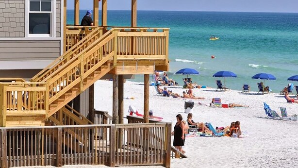 A beach house with a wooden deck and a lifeguard tower. - 🌊Fully Renovated | 500ft to Beach | 2 BR | Beach Within Reach🌊 (Miramar Beach)