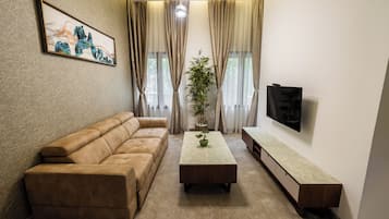 Deluxe Apartment | Living area | 32-inch Smart TV with cable channels