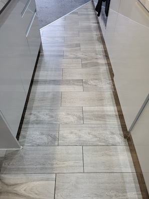 A hallway with a wooden floor and white walls. - Best Priced Apartment in Danum 2 (Doncaster)