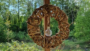 A wooden structure with a decorative metal ring and a hanging light fixture. - Just take a break, Sauerland, Alme Brilon (Brilon)