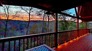 A wooden deck with a railing, a bench, and a view of trees and hills. - Mountain Mist - Secluded Cabin, MTN View, Hot Tub! (Sevierville)