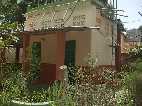 A small building with two green doors, one labeled "TOILETTE". - Camping-Sukuta & Lodge (Serrekunda)