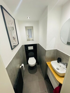 Een haardroger, handdoeken, zeep, toiletpapier