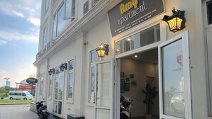 A two-story building with a sign for 'Amy Apartment'. - Phu My An Apartment Hue (Hue)