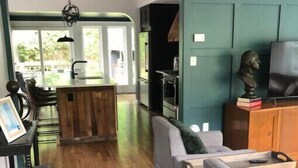 A modern living room with a wooden floor, grey sofas, and a wooden coffee table. - Binghamton's Beautiful Riverside Drive Living!
 (Binghamton)