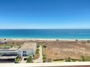 A coastal view with a beach, a building labeled "Pestana Alvor South Beach," and a clear sky.