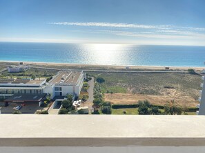 A coastal view with a building and a beach.