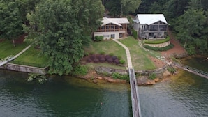 A lakeside property with two main buildings, a dock, and a bridge. - Lake Front w/ Sunset Views, Screened-in Porch / 1x Boat Slip / 2x Kayaks (Jasper)