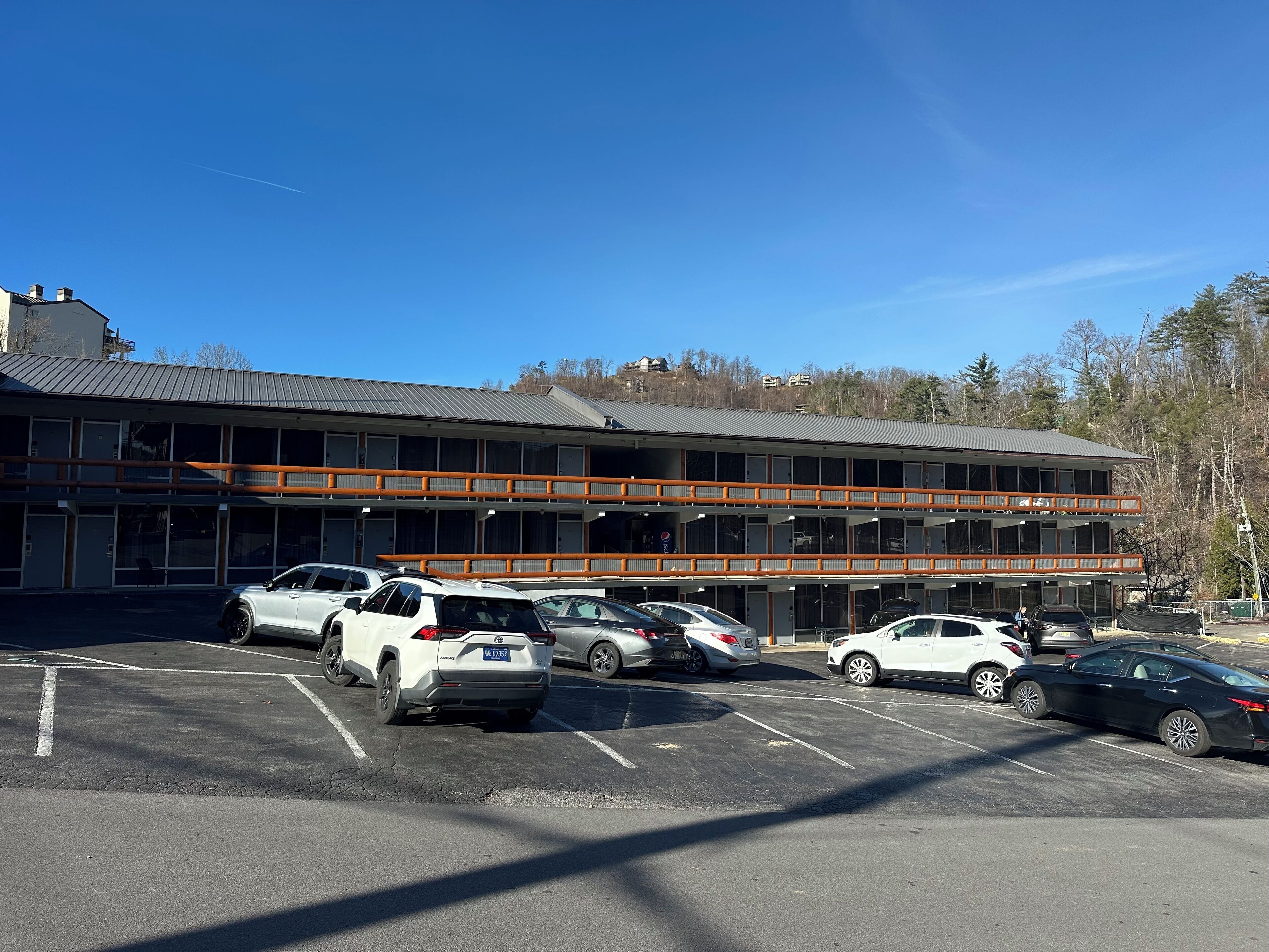 A multi-story hotel with a parking lot.
