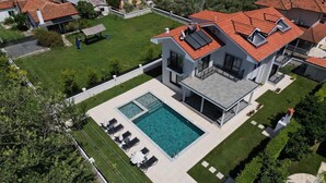 A modern two-story house with a swimming pool, a covered patio, and a well-maintained lawn. - Safe, central, lux and comfortable holiday in Dalyan. (Dalyan)