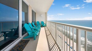A balcony with turquoise chairs and a view of the ocean. - Majestic Tower II - 22nd-Floor Beachfront Condo | Panoramic Gulf Views (Panama City Beach)