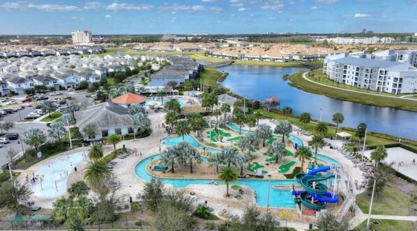 Relax by the pool or take a refreshing dip in the water slide surrounded by palm trees and a sandy beach area.